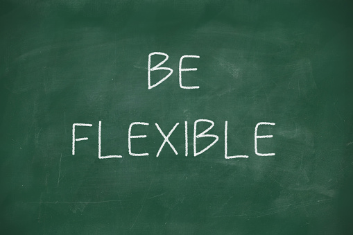 Be flexible handwritten on school blackboard