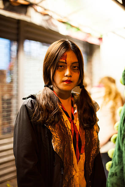 New York City, NY, USA - October 31, 2014: An Asian woman is dressed up as a Japanese Zombie Student for Halloween.   