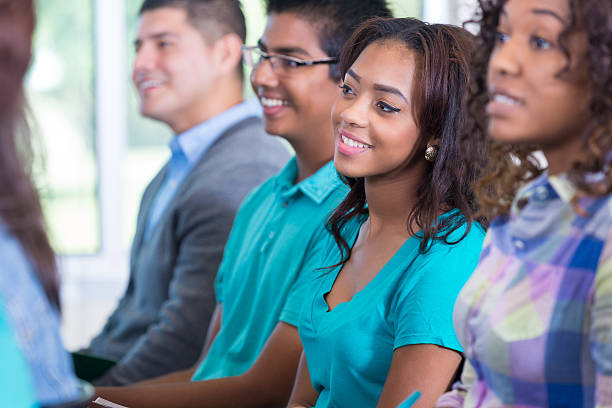 Group of students sitting during orientation meeting in auditorium