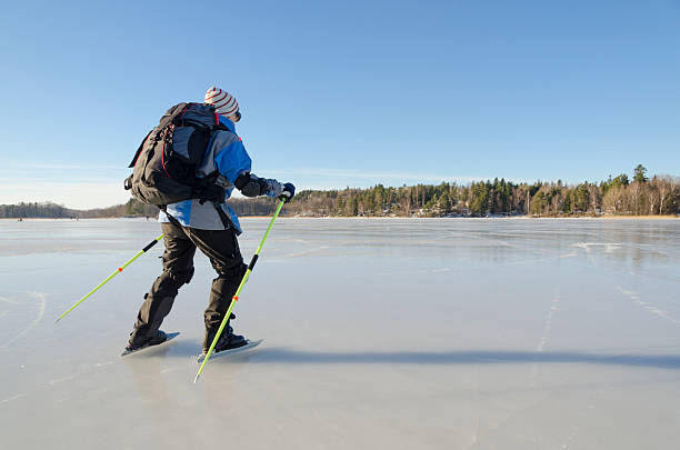 Mature woman skating on a lake near Stockholm stock photo