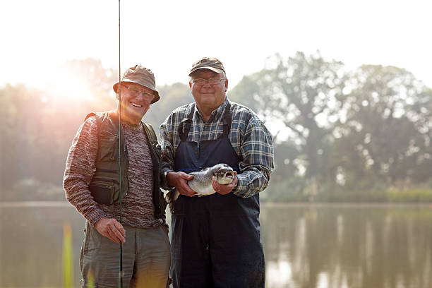 senior los pescadores con la cortina y pescado fresco - fly fishing fishing river fisherman fotografías e imágenes de stock