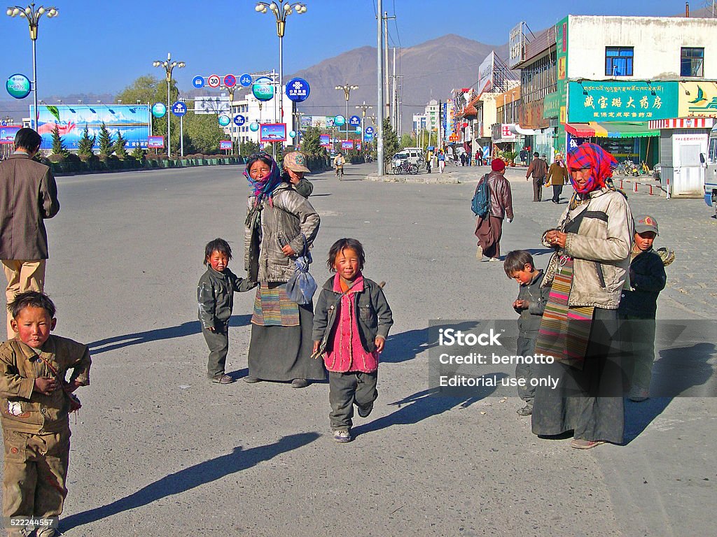 Lhasa, Tibet, China: pilgrims chatting and begging. Lhasa, Tibet, China - November 13, 2004: pilgrims chatting and begging in front of the Potala palace. The Palace is the Tibet historic and political landmark.  Arts Culture and Entertainment Stock Photo