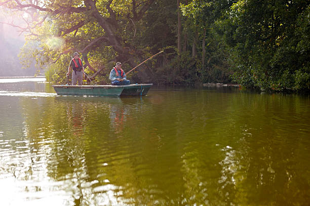 istock Senior buddies on a small boat fishing 522245231
