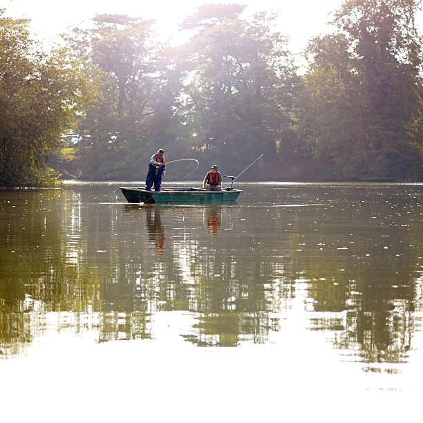 istock Two men fly fishing from a small boat 522245245