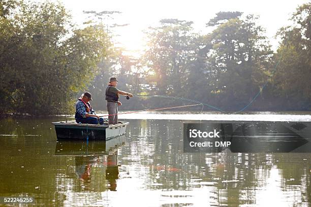 Two Senior Men In A Boat Fishing Stock Photo - Download Image Now - Fishing, River, Fishing Boat