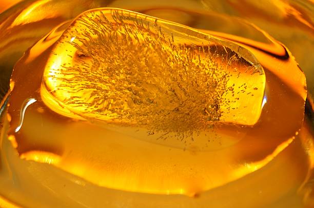 istock close-up ice cube melting in orange glow 522245329