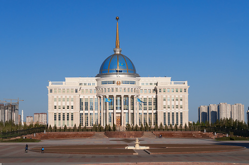 Astana, Kazakhstan - May 9, 2014:  Presidential Palace Ak-Orda  is the official workplace of the President of Kazakhstan. People walk along the street