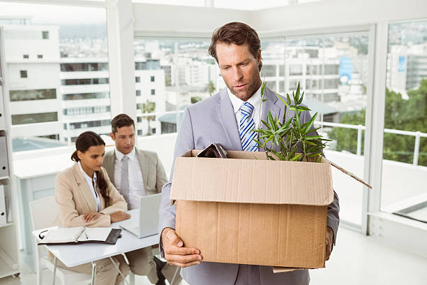 istock Businessman carrying his belongings in box 522246455