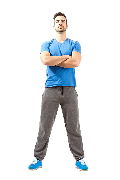 Confident fit guy posing with crossed hands and head back