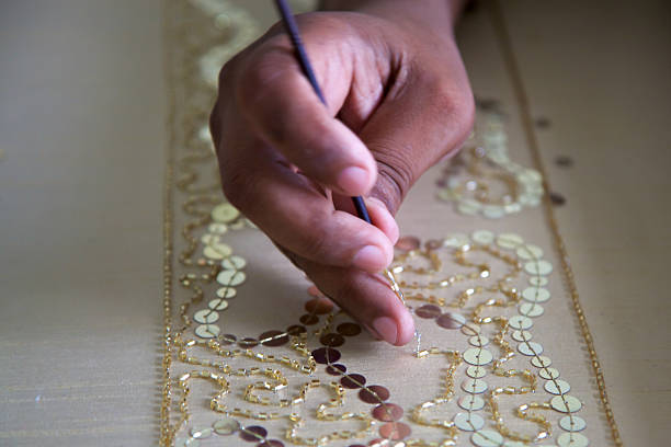 Hand-embroidery in a fair-trade workshop, Agra stock photo