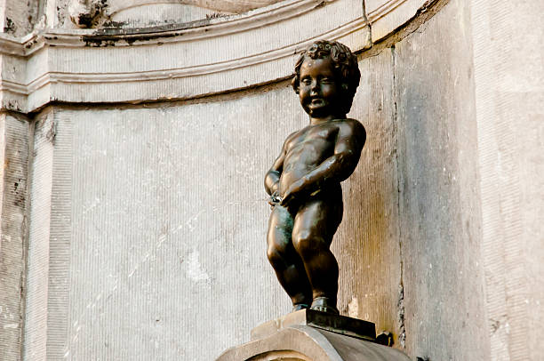 Bronze Sculpture of Manneken Pis as View Through the Iron Fence, a Small but Famous Landmark of Brussels of Belgium