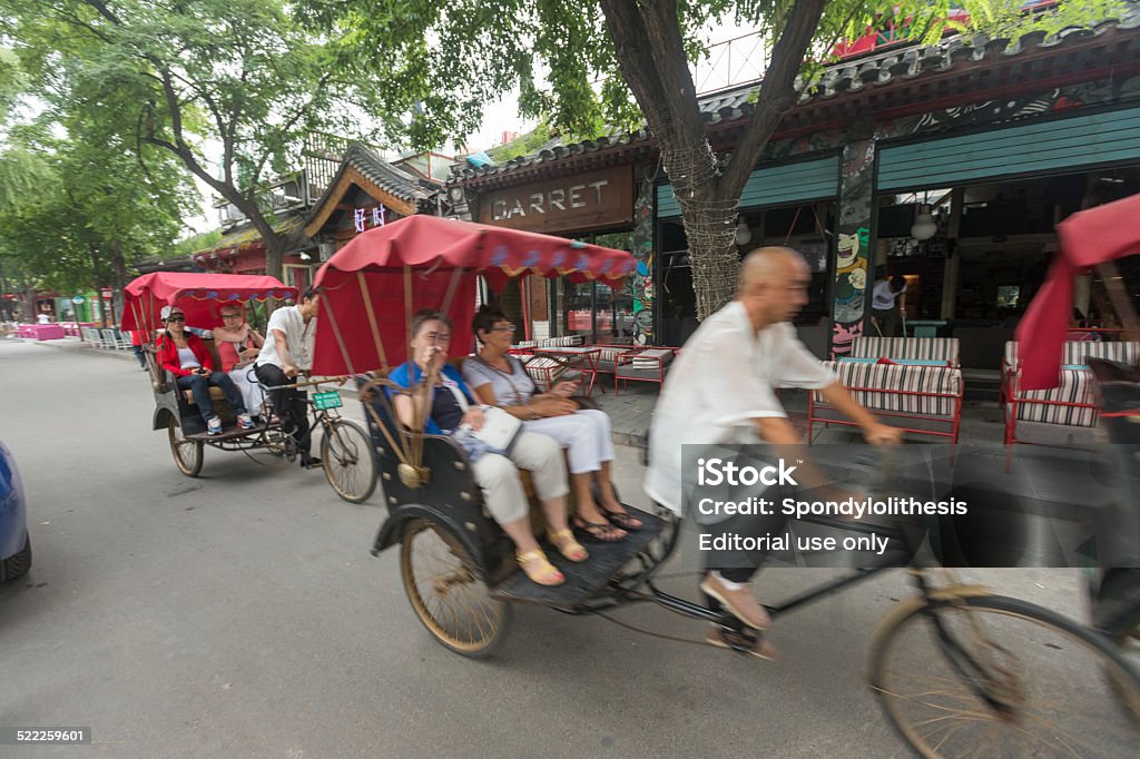 Beijing hutong tour by pedicab Beijing, China - September 12, 2014: Tourist Enjoy Beijing Hutong Pedicab Ride Asia Stock Photo