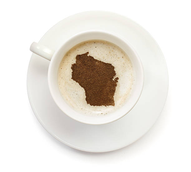 Coffeecup with powder in the shape of Wisconsin A top shot of a cup of coffee with froth and powder in the shape of Wisconsin (USA).(series)   How about having a break :) wisconsin photos stock pictures, royalty-free photos & images