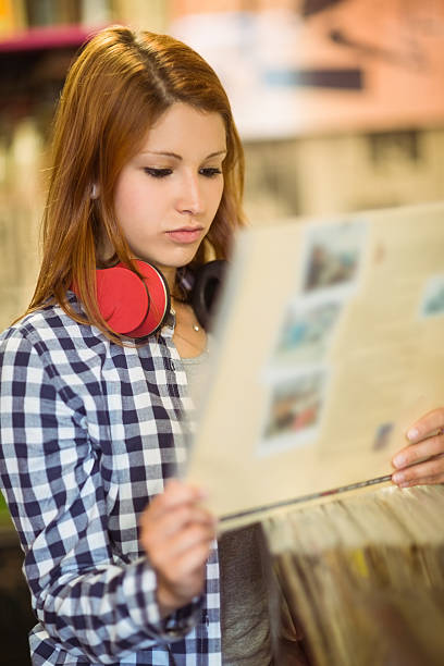 istock Redhead with check shirt holding a vinyl 522263575