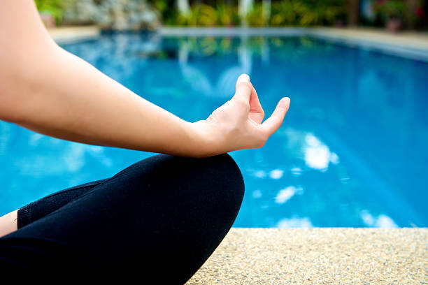 istock Yoga Meditation hand by pool 522263969