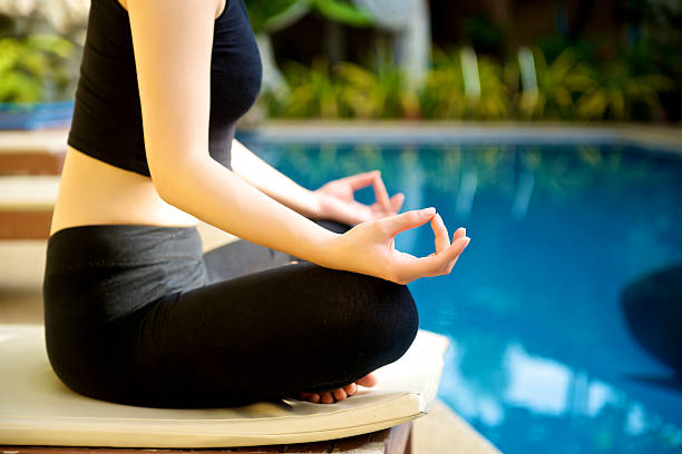 istock Yoga Meditation hand by pool 522275073