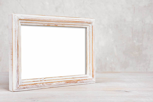 Old painted photo frame on table over abstract background