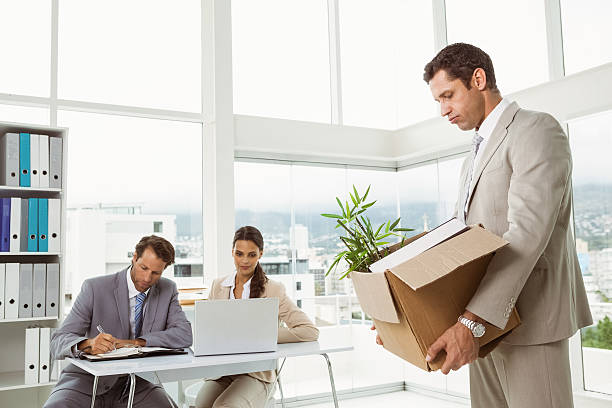 istock Businessman carrying his belongings in box 522276375