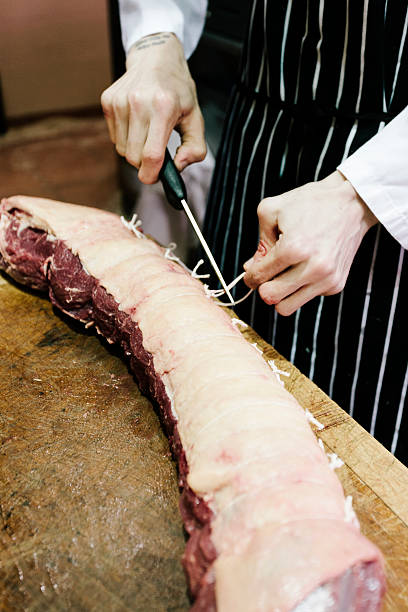 istock British Butcher, preparing a joint of beef 522278403