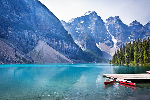 Lake Moraine and Canoe Dock in Banff National Park Lake Moraine in the Banff National Park of Canada, with its emerald water and mountain range of the Canadian Rockies. moraine lake photos stock pictures, royalty-free photos & images