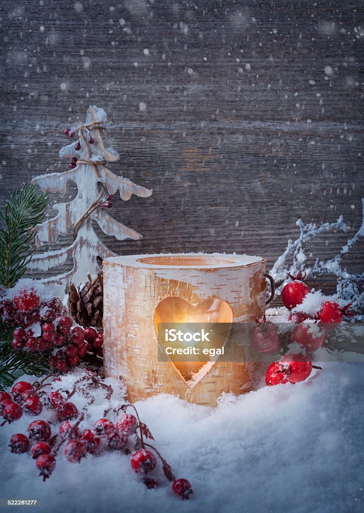 Winter candle Winter candle on a wooden background Christmas Stock Photo