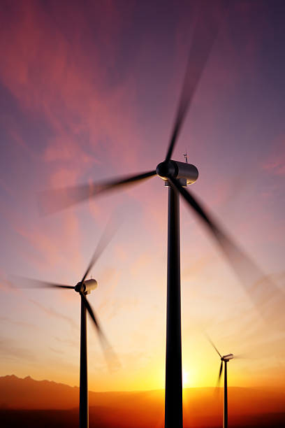 wind turbine spinning at sunset hojas - wind turbine motion alternative energy wind power fotografías e imágenes de stock