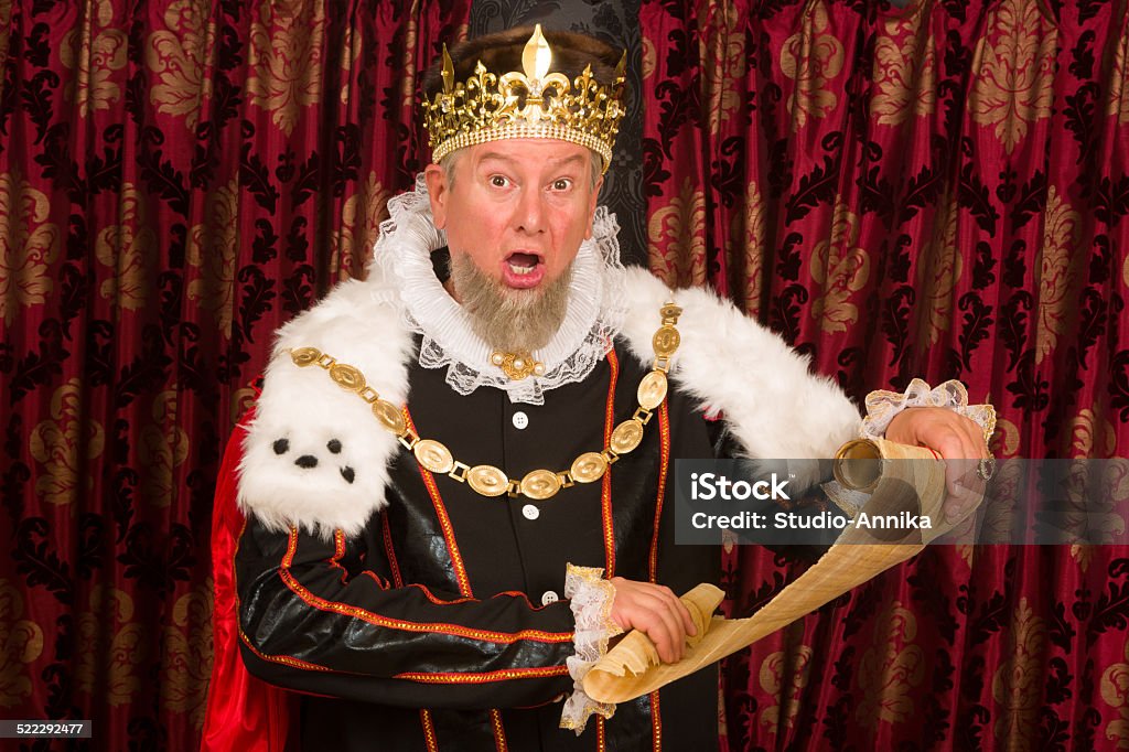 King with parchment scroll Senior king making an announcement holding a parchment scroll King - Royal Person Stock Photo