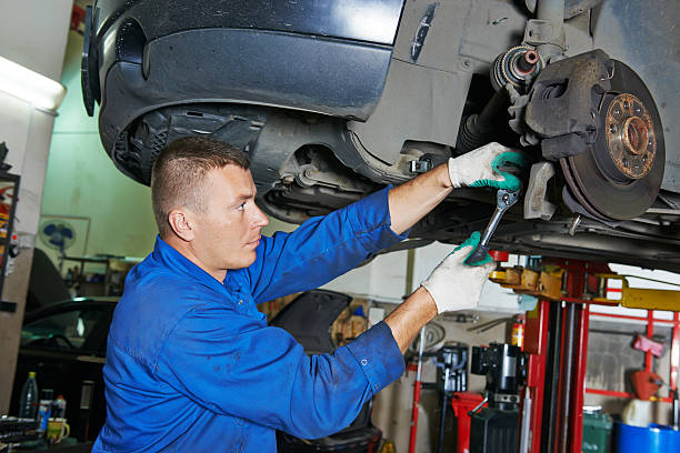 istock auto mechanic at car suspension repairing 522292841