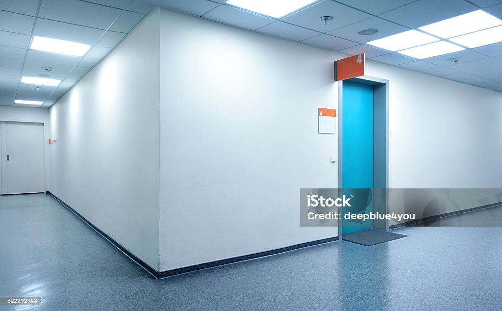 Empty white Hospital corridor with a blue door Hospital corridor Hospital Stock Photo