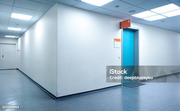 Empty White Hospital Corridor With A Blue Door Stock Photo - Download Image Now - Hospital, Corridor, Door