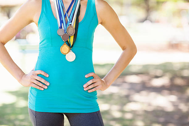 istock Female Athlete Wearing Various Medals At Park 522293541