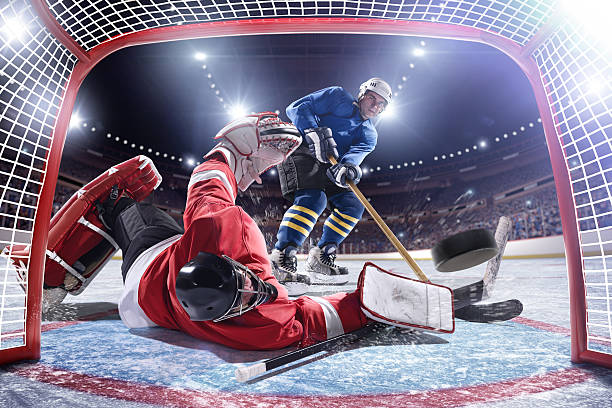 ice hockey player-punkten - ice hockey hockey puck playing shooting at goal stock-fotos und bilder