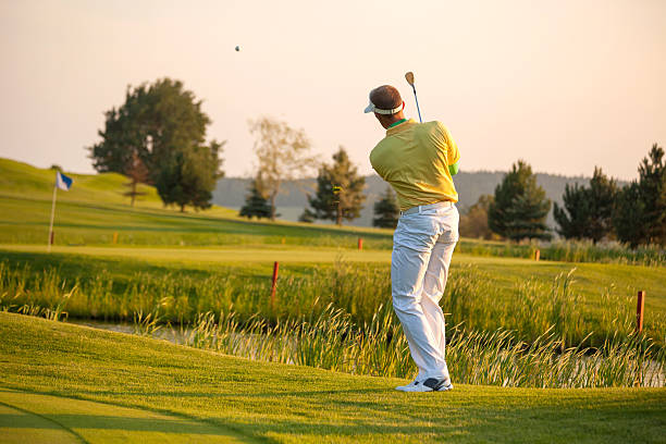 Man playing golf Man playing golf during a sunny day golfer swinging club stock pictures, royalty-free photos & images