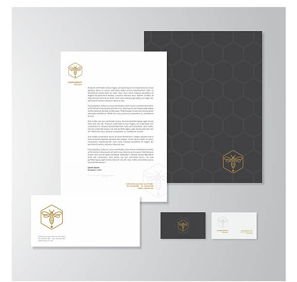 Honey production company stationery design Stationery design for a honey production company. Letterhead, folder, envelope and business card with logo. All design elements are layered and grouped. Eps10, contains transparent objects. black and gold business cards stock illustrations