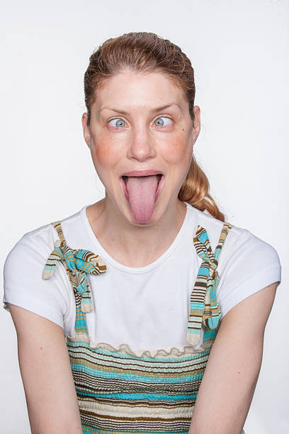 istock Young woman sticking tongue out 522301940