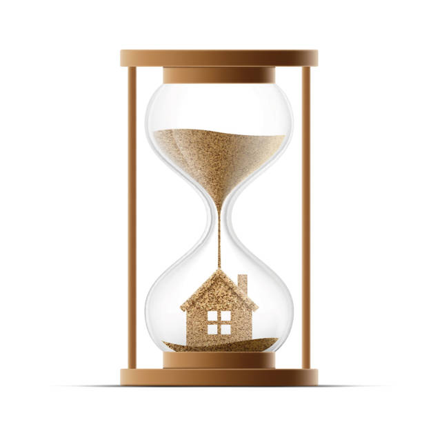 istock Hourglass with the house. Construction of real estate. 522305804