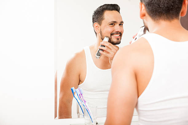 istock Young man shaving his beard and smiling 522308934
