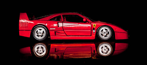 Solkan, Slovenia - September 21, 2013: Red Ferrari F40 modell car with a reflection in the foreground isolated on black in a studio.