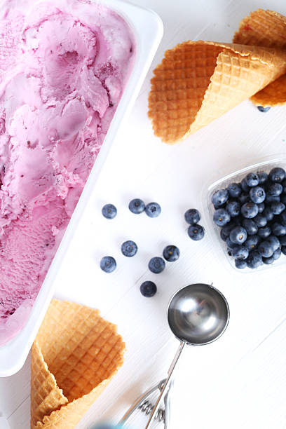 istock Waffle cone with blueberries and ice cream on wooden table 522309612