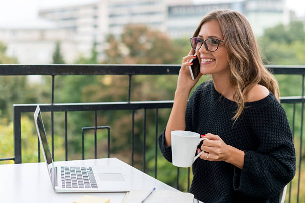 istock Smiling Young woman talking on mobile phone 522309848