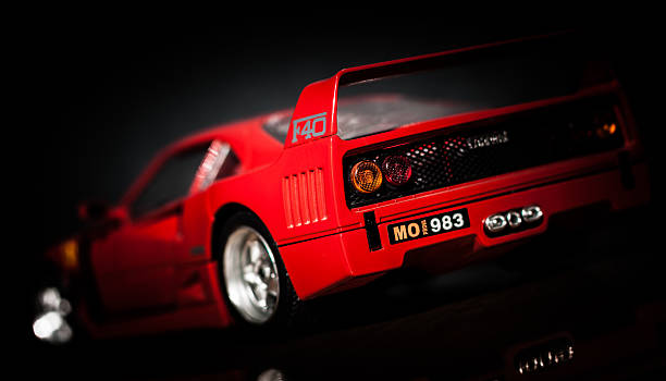 Solkan, Slovenia - September 3, 2013: Red Ferrari F40 modell car rear view with a reflection in the foreground isolated on black in a studio.