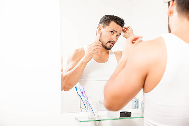 istock Attractive man combing his hair in the bathroom 522310290
