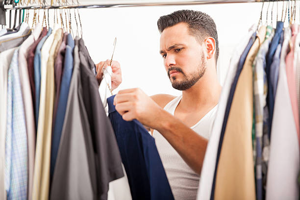 istock Young man deciding what clothes to wear 522310576