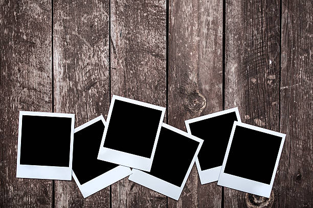 istock Blank photographs on wooden background 522311305