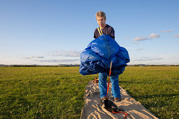 istock man packs  blue parachute 522311831