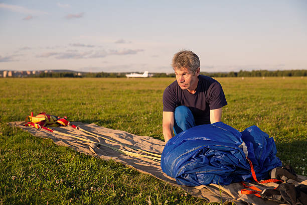 istock man packs  blue parachute 522311835