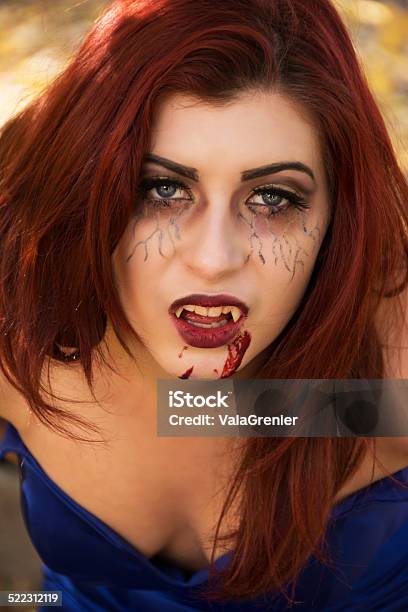 Redheaded Teen Vampire Outdoors Leaning Toward Camera Stock Photo - Download Image Now