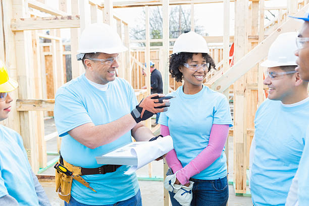 istock Group of volunteers discuss charity building project 522312932