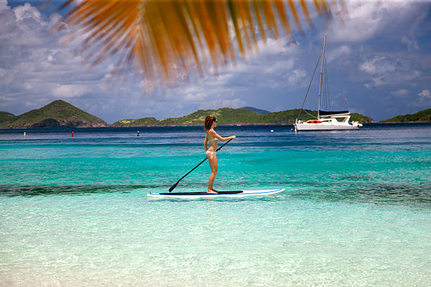 istock woman paddling on stand up paddle board, St.John, USVI 522313807