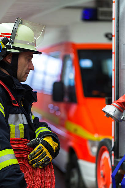 istock Firefighter wearing a rolled fire hose to the emergency truck 522313910